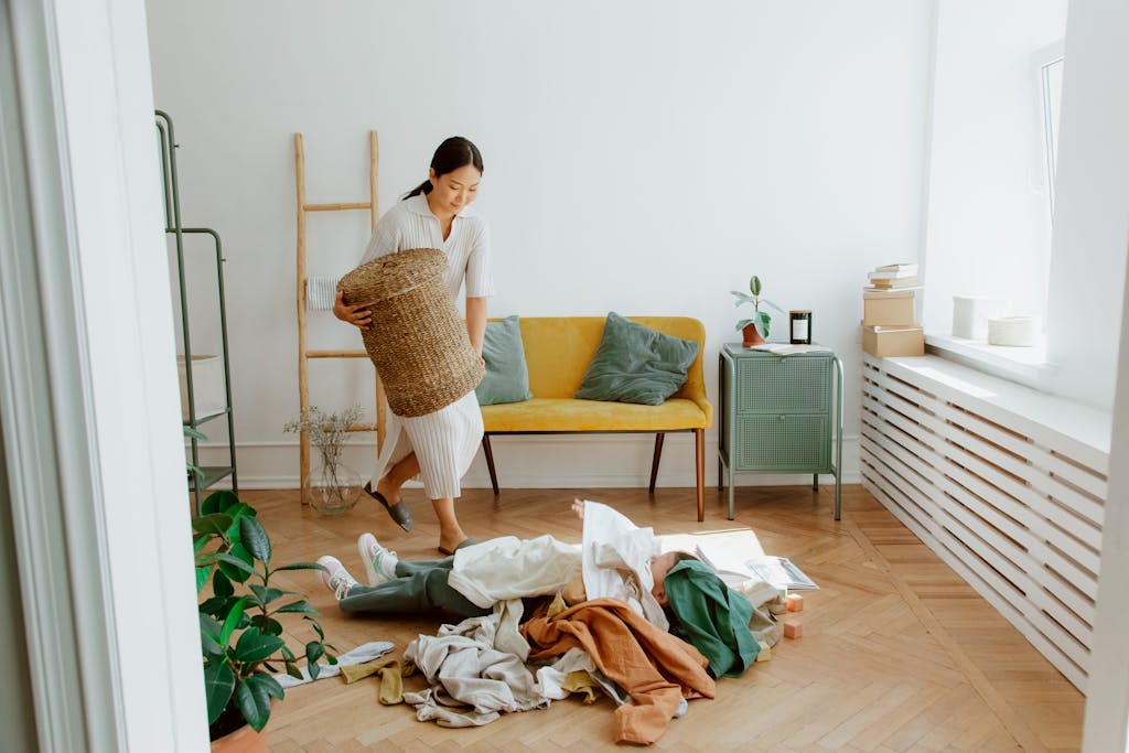 A woman organizing clothes in a cozy living room, creating a tidy and welcoming atmosphere.